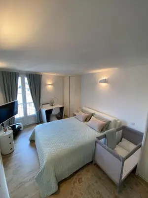 a bedroom with a large bed and a couch at Au cœur de la Vieille Ville in Ajaccio