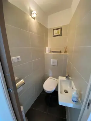 a small bathroom with a toilet and a sink at Au cœur de la Vieille Ville in Ajaccio