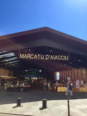 a market with people walking in front of a building at Au cœur de la Vieille Ville in Ajaccio