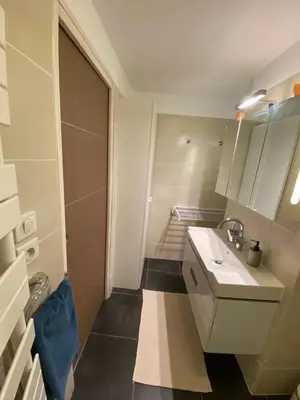 a bathroom with a sink and a mirror at Au cœur de la Vieille Ville in Ajaccio