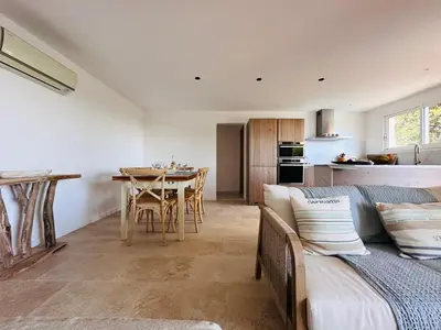 a living room with a couch and a table at BENEDETU in Porto-Vecchio