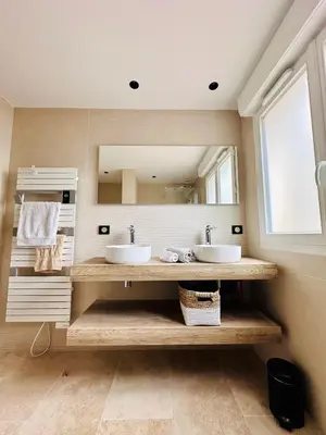 a bathroom with two sinks and a large mirror at BENEDETU in Porto-Vecchio