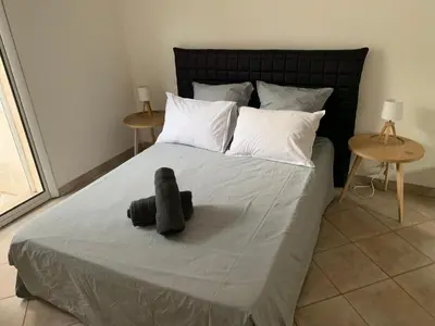a bedroom with a bed with a stuffed animal on it at BENEDETU in Porto-Vecchio