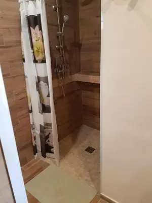 a shower with a shower curtain in a bathroom at L Appicciu in Ventiseri