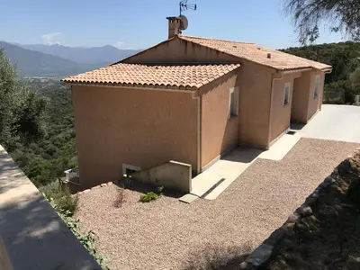 a small house with a view of a mountain at ELI&LOU avec piscine in Alata