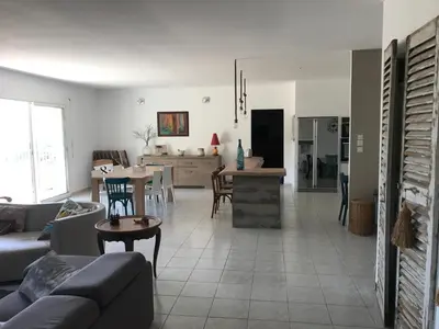 a living room with a couch and a table at ELI&LOU avec piscine in Alata