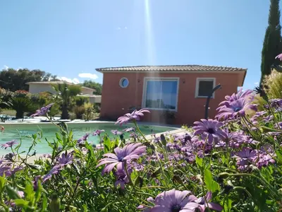 a garden with purple flowers in front of a house at Villa di Pardisoli in Prunelli-di-Fiumorbo