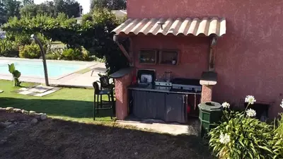 a barbecue outside of a house with a pool at Villa di Pardisoli in Prunelli-di-Fiumorbo