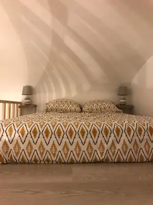 a bedroom with a large bed with two lamps at Studio plein centre ville in Ajaccio