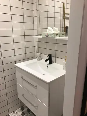 a white bathroom with a sink and a mirror at Studio plein centre ville in Ajaccio