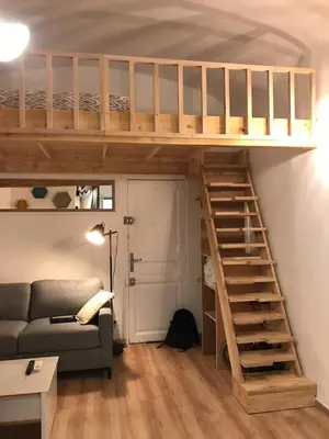 a loft bed in a living room with a couch at Studio plein centre ville in Ajaccio