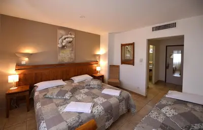 a hotel room with a bed and a hallway at Hôtel A casa di Maria Cicilia in Ghisonaccia
