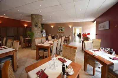 a dining room with wooden tables and chairs at Hôtel A casa di Maria Cicilia in Ghisonaccia