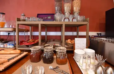 a counter with jars of honey and other items at Hôtel A casa di Maria Cicilia in Ghisonaccia