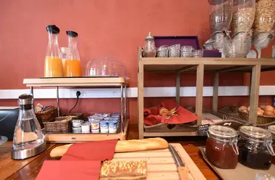 a table with bread and other items on it at Hôtel A casa di Maria Cicilia in Ghisonaccia