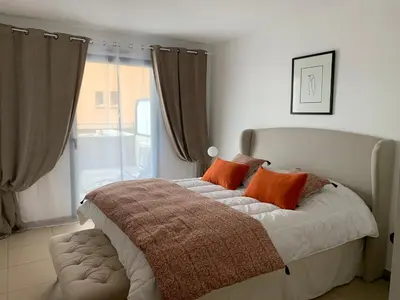 a bedroom with a bed with orange pillows and a window at Fronte di Mare in Propriano