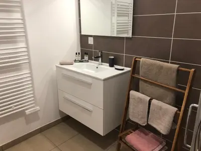 a bathroom with a white sink and a mirror at Fronte di Mare in Propriano