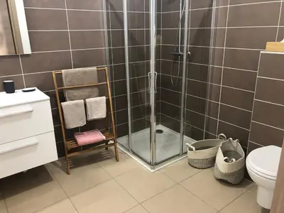 a shower with a glass door in a bathroom at Fronte di Mare in Propriano