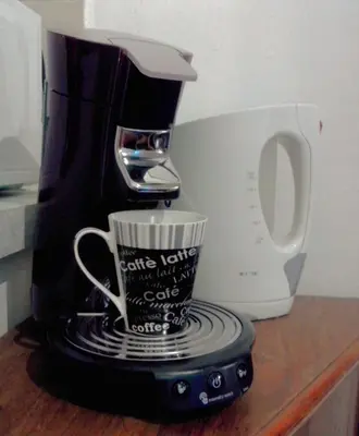 a coffee maker and a coffee cup on a counter at Le Studio du Cardinal Central/ Wifi/ Ajaccio à pieds! in Ajaccio