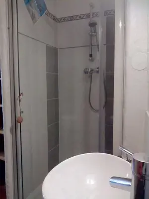a bathroom with a shower and a white sink at Le Studio du Cardinal Central/ Wifi/ Ajaccio à pieds! in Ajaccio