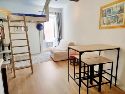a room with a bunk bed and a table and a desk at Le Studio du Cardinal Central/ Wifi/ Ajaccio à pieds! in Ajaccio