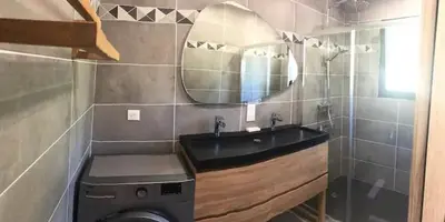 a bathroom with a black sink and a mirror at Villa Ucellu sur 600 m2 avec accès mer privilégié et piscine privée chauffée in Sainte-Lucie de Porto-Vecchio