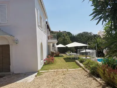 a white house with a patio and a pool at Villa Via serena in Ajaccio