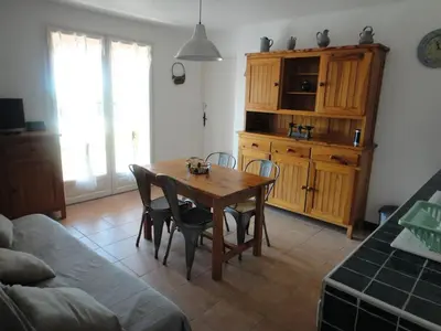 a living room with a wooden table and chairs at Villa Via serena in Ajaccio