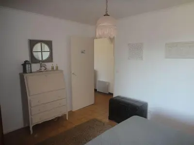 a bedroom with a bed and a dresser and a mirror at Villa Via serena in Ajaccio
