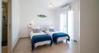a bedroom with two beds with blue and white sheets at Au Cœur de l'arrière pays DOMAINE A PRESA Villas avec Piscine Privée & chauffée in Matra