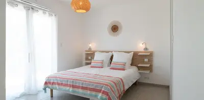 a white bedroom with a bed with two pillows at Au Cœur de l'arrière pays DOMAINE A PRESA Villas avec Piscine Privée & chauffée in Matra