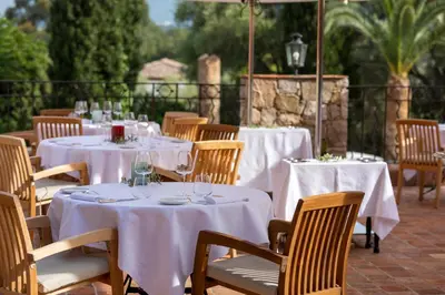 a group of tables with white table cloths on them at La Signoria & Spa in Calvi