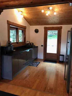 a kitchen with a counter and a door in a room at Grande maison avec piscine in Porto-Vecchio
