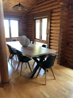 a wooden dining room with a table and chairs at Grande maison avec piscine in Porto-Vecchio