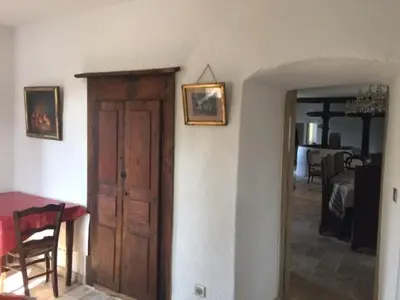 a room with a door and a table and a dining room at Le Moulin de l'Ostriconi in Novella