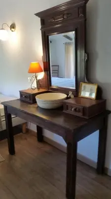 a table with a mirror and a bowl on it at Le Moulin de l'Ostriconi in Novella