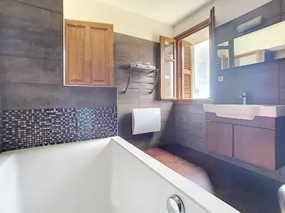 a bathroom with a tub and a sink at Domaine de Tappa - Casa Filicina in Sollacaro