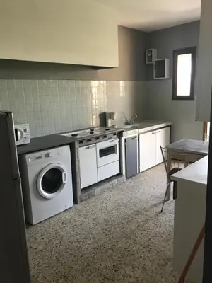 a kitchen with a washing machine and a washer at U Ricordu in Prunelli-di-Fiumorbo