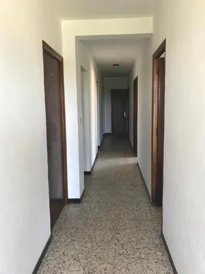 a hallway of an empty building with doors and a hallwayngth at U Ricordu in Prunelli-di-Fiumorbo