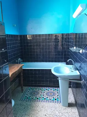a blue bathroom with a tub and a sink at U Ricordu in Prunelli-di-Fiumorbo
