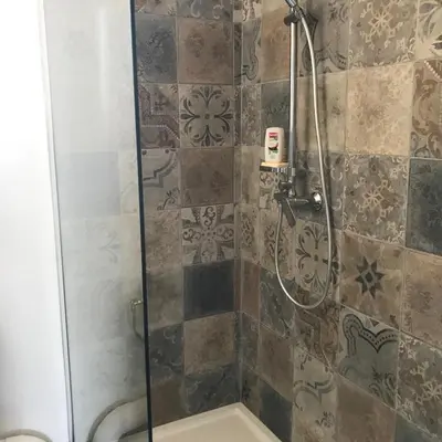 a bathroom with a shower with a glass door at U Ricordu in Prunelli-di-Fiumorbo