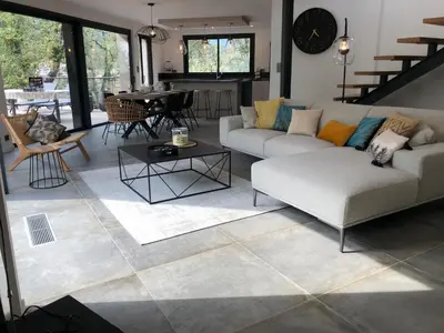 a living room with a couch and a table at Pavillon de la Trinité in Porto-Vecchio