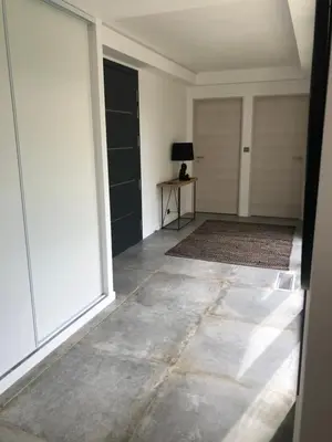 an empty hallway with a large window and a table at Pavillon de la Trinité in Porto-Vecchio