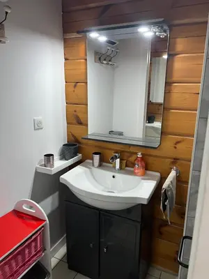 a bathroom with a white sink and a mirror at Chalet zen in Peri