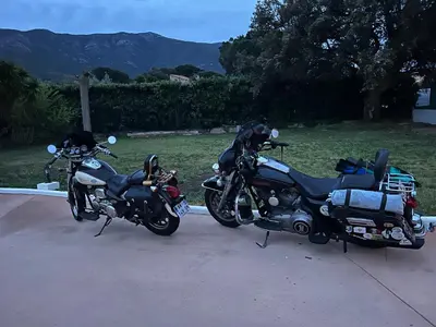 two motorcycles parked next to each other on a driveway at Chalet zen in Peri