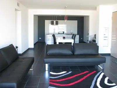 a living room with a couch and a table at Appart 8 pers vue sur baie - Porticcio in Porticcio
