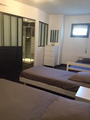 a bedroom with two twin beds and a window at Appart 8 pers vue sur baie - Porticcio in Porticcio