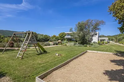 a playground with a ladder in a yard at Villa 19 in Zonza