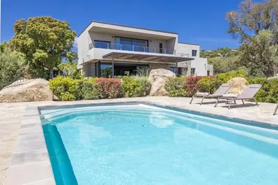 a house with a swimming pool in front of a house at Villa 19 in Zonza