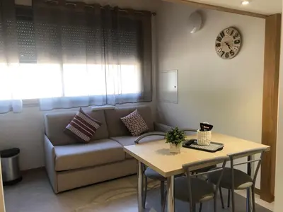 a living room with a couch and a table at Résidence Porto Marine in Porto Ota